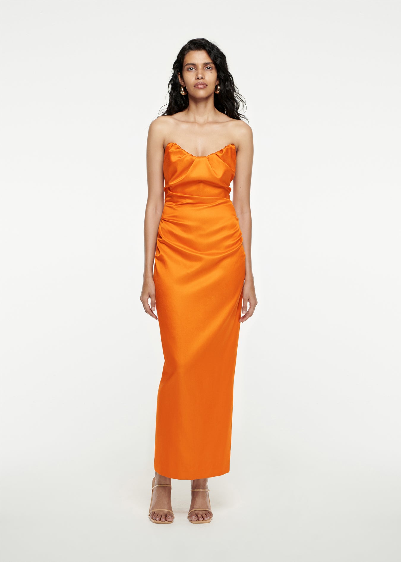 Woman wearing the Strapless Satin Maxi Dress in Orange