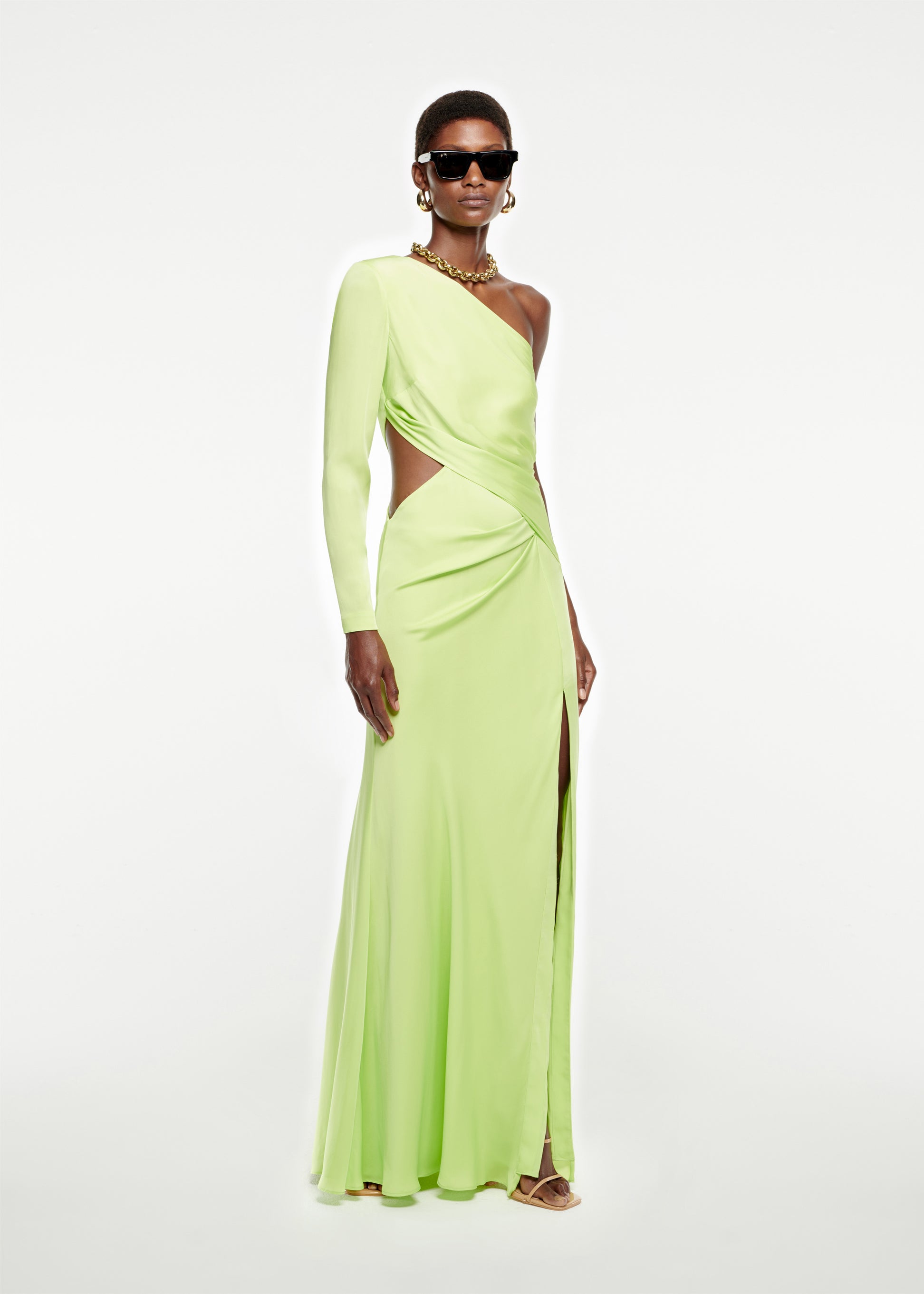 Woman wearing the Asymmetric Stretch Silk Crepe Gown in Green