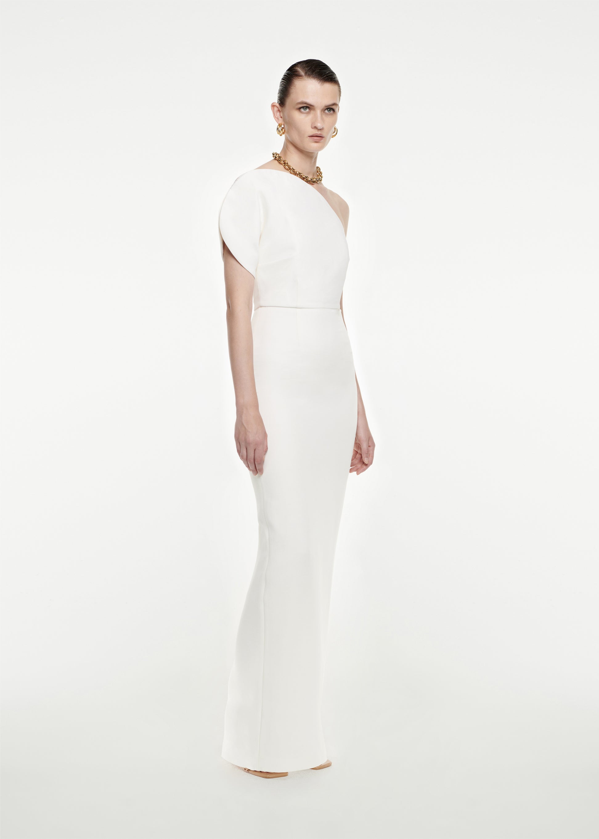 Woman wearing the Asymmetric Silk Wool Maxi Dress in White